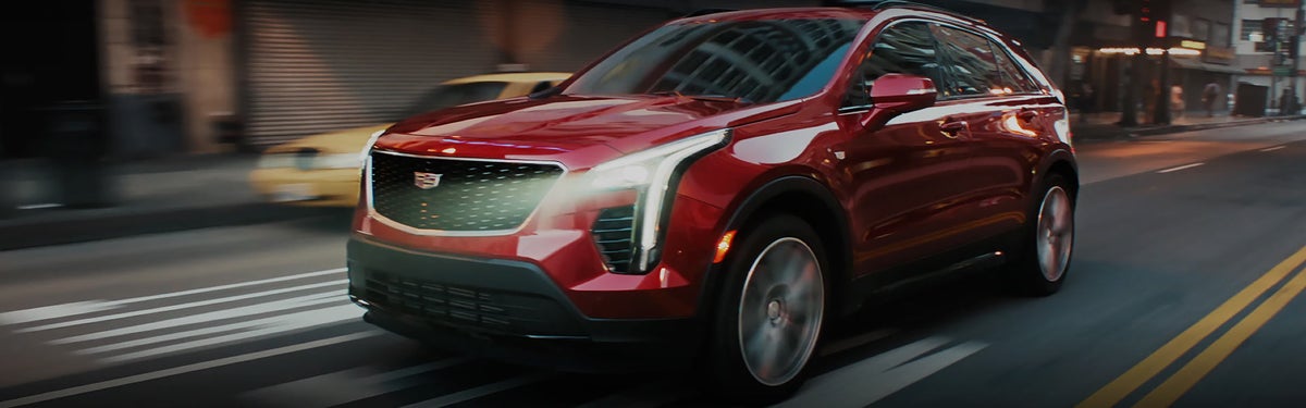 red 2020 XT4 Cadillac vehicle driving on the road 