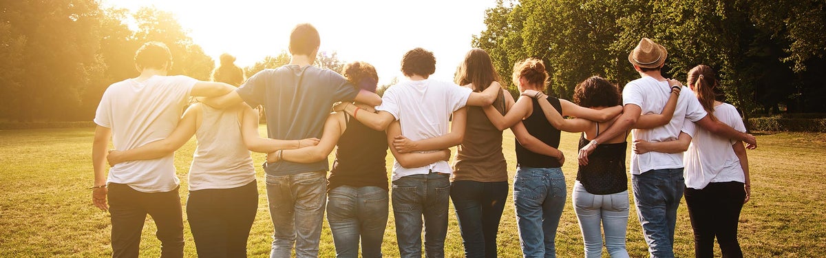 Group of people holding each other